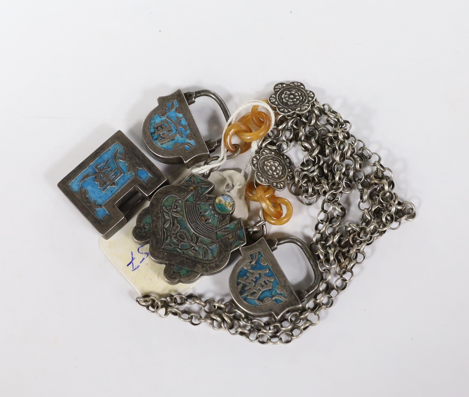 A Chinese white metal and enamel pendant on chain, overall 56cm and three similar padlocks.